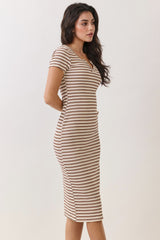 woman wearing a fitted short sleeve striped midi dress in beige and rust colors