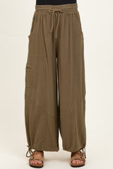 woman wearing olive green maternity wide-leg pants with pockets and adjustable ties at the hem
