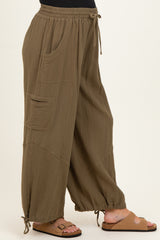 woman wearing olive green maternity wide-leg pants with side pockets and adjustable drawstring hem