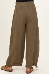 woman wearing olive green maternity wide-leg pants with adjustable drawstring hem and elastic waistband