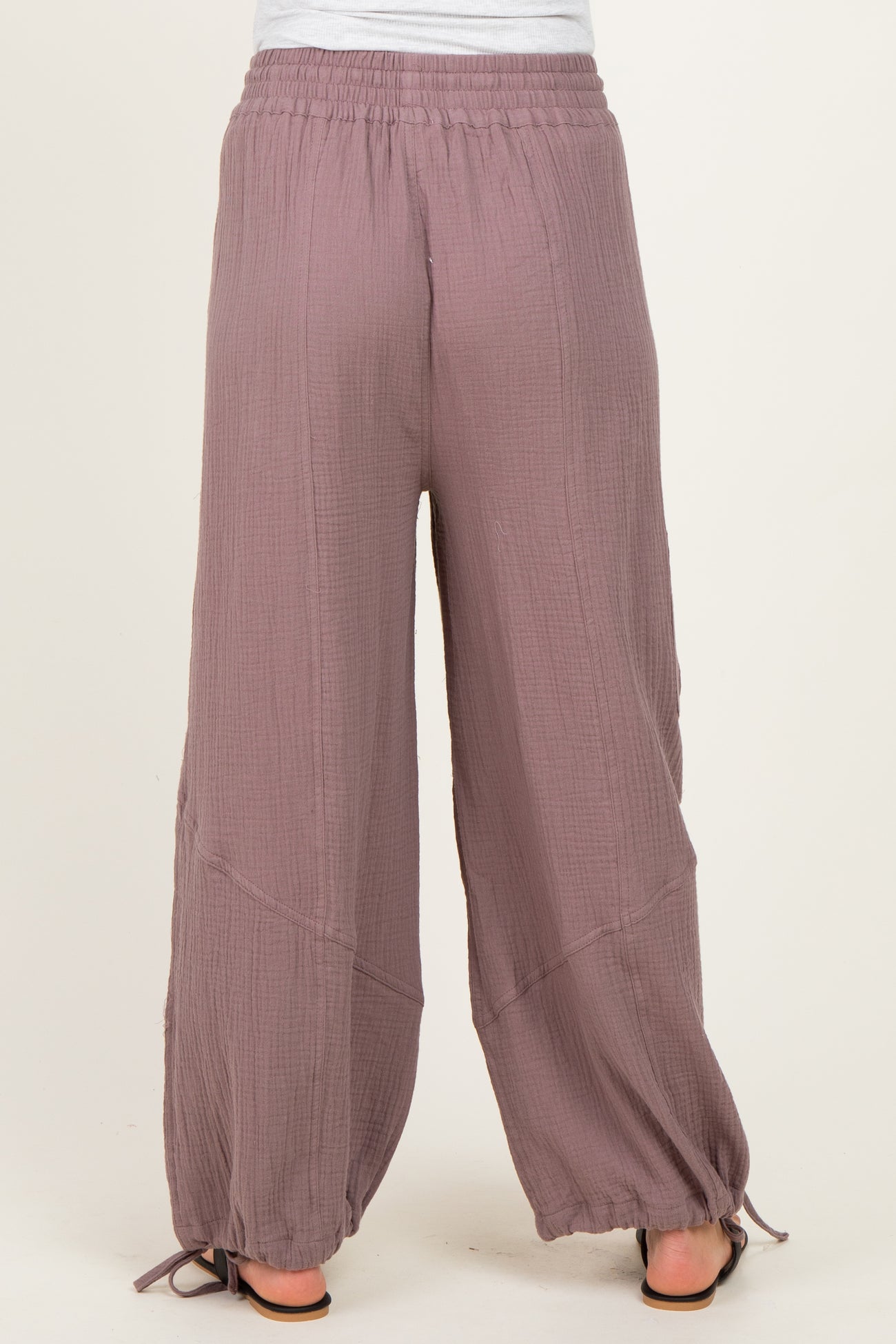 woman wearing mauve maternity wide-leg pants with an elastic waistband and drawstring hem