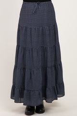 woman wearing a navy and white checked maternity maxi skirt with tiered ruffles and an elastic waistband
