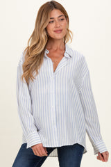 woman wearing a white and blue striped maternity blouse with a relaxed fit and button-down front, showcasing her baby bump
