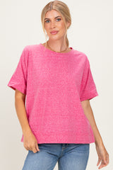 woman wearing a bright pink short sleeve oversized t-shirt with a relaxed fit and denim jeans