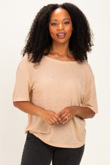 woman wearing a beige oversized short sleeve t-shirt with a scoop neckline and textured fabric