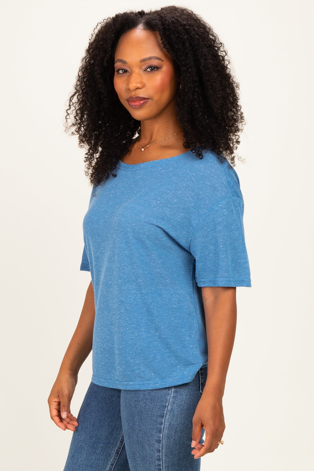 woman wearing a blue short sleeve relaxed fit t-shirt and high-waisted jeans