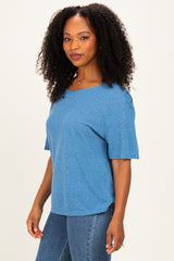 woman wearing a blue short sleeve relaxed fit t-shirt and high-waisted jeans