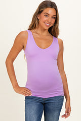 woman wearing a lavender maternity tank top with a v-neck and baby bump visible, paired with blue jeans
