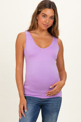 woman wearing a lilac maternity tank top and holding her baby bump