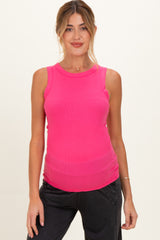 woman wearing a bright pink sleeveless maternity top with a fitted style and visible baby bump
