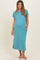 woman wearing a teal maternity dress with short sleeves, pockets, and side slits, showing her baby bump