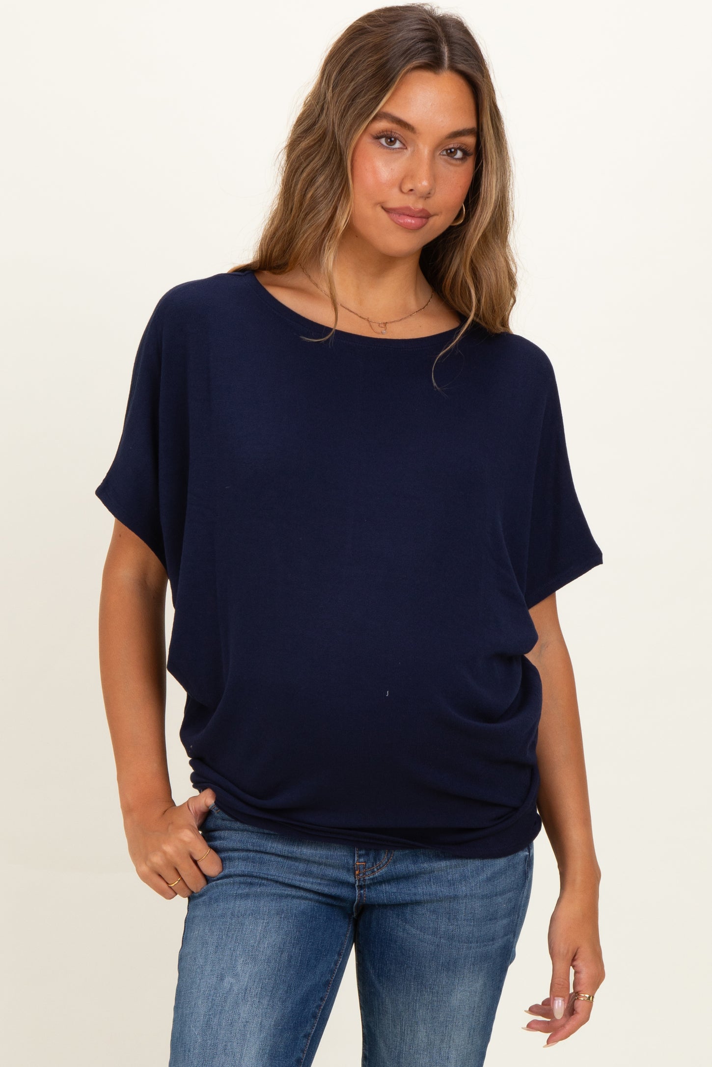 woman wearing a navy blue short sleeve maternity top with a relaxed fit and baby bump visible