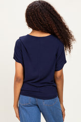 woman wearing a navy blue short sleeve top with a relaxed fit and back seam detail