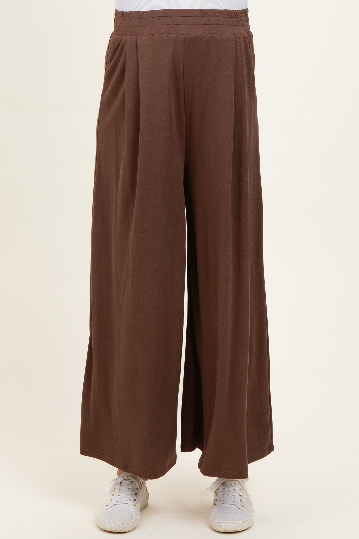 maternity wear wide-leg brown pants with an elastic waistband, model standing casually