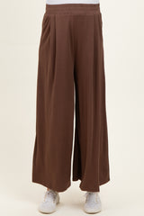 maternity wear wide-leg brown pants with an elastic waistband, model standing casually
