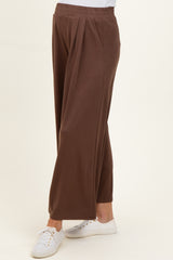 maternity wear brown wide-leg pants with a comfortable waistband and pockets, styled with white sneakers