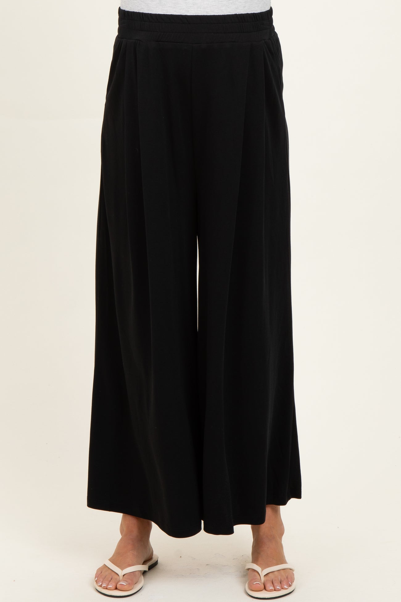 woman wearing black wide-leg maternity pants with a comfortable waistband