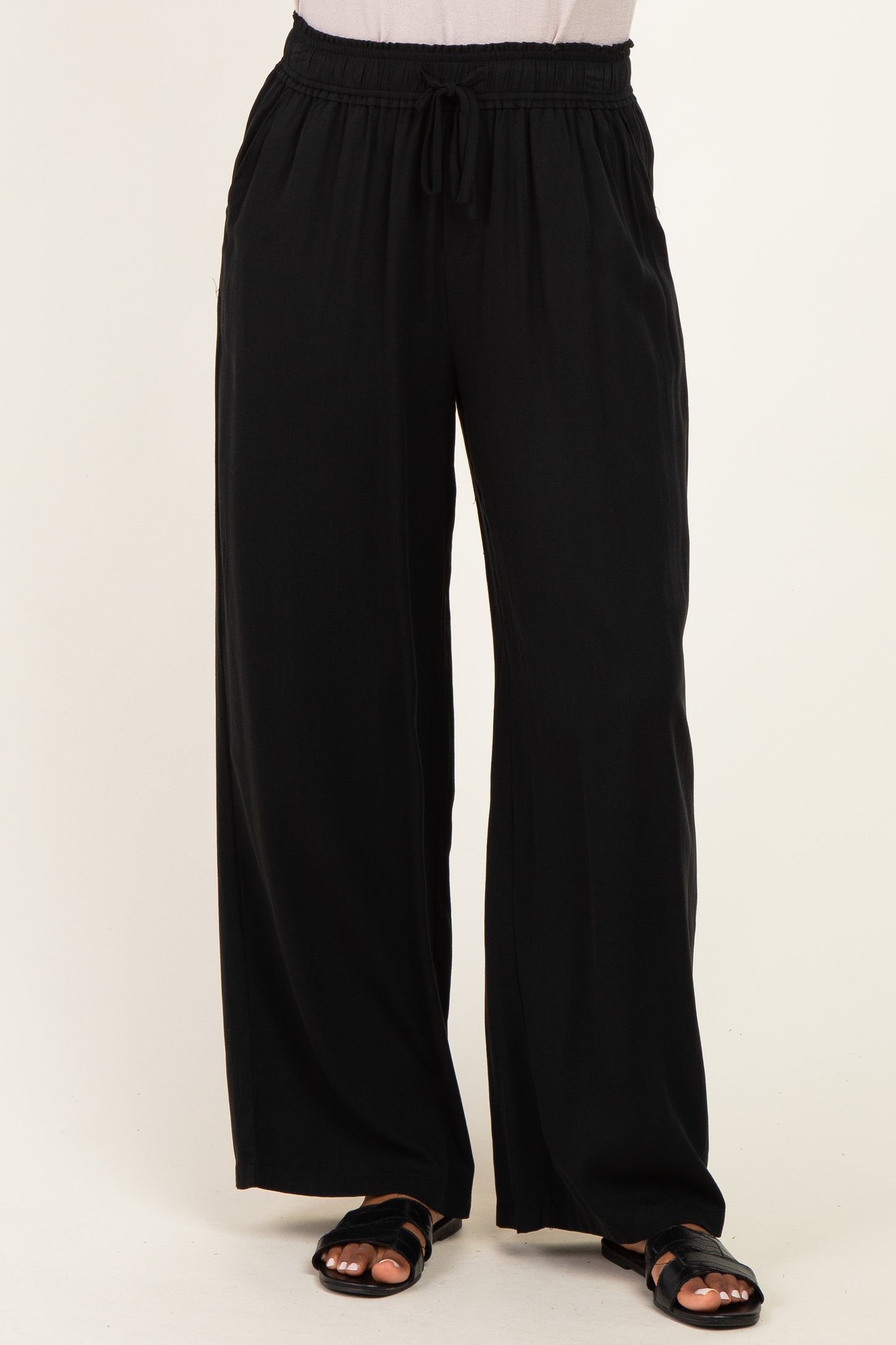 woman wearing black wide-leg pants with an elastic waistband and side pockets
