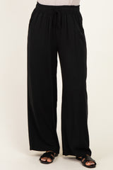 woman wearing black wide-leg pants with an elastic waistband and side pockets