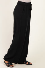 woman wearing black wide-leg pants with an elastic waistband and drawstring detail