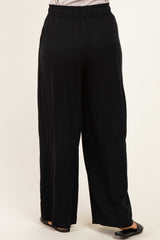 woman wearing black wide-leg trousers with an elastic waistband, shown from the back