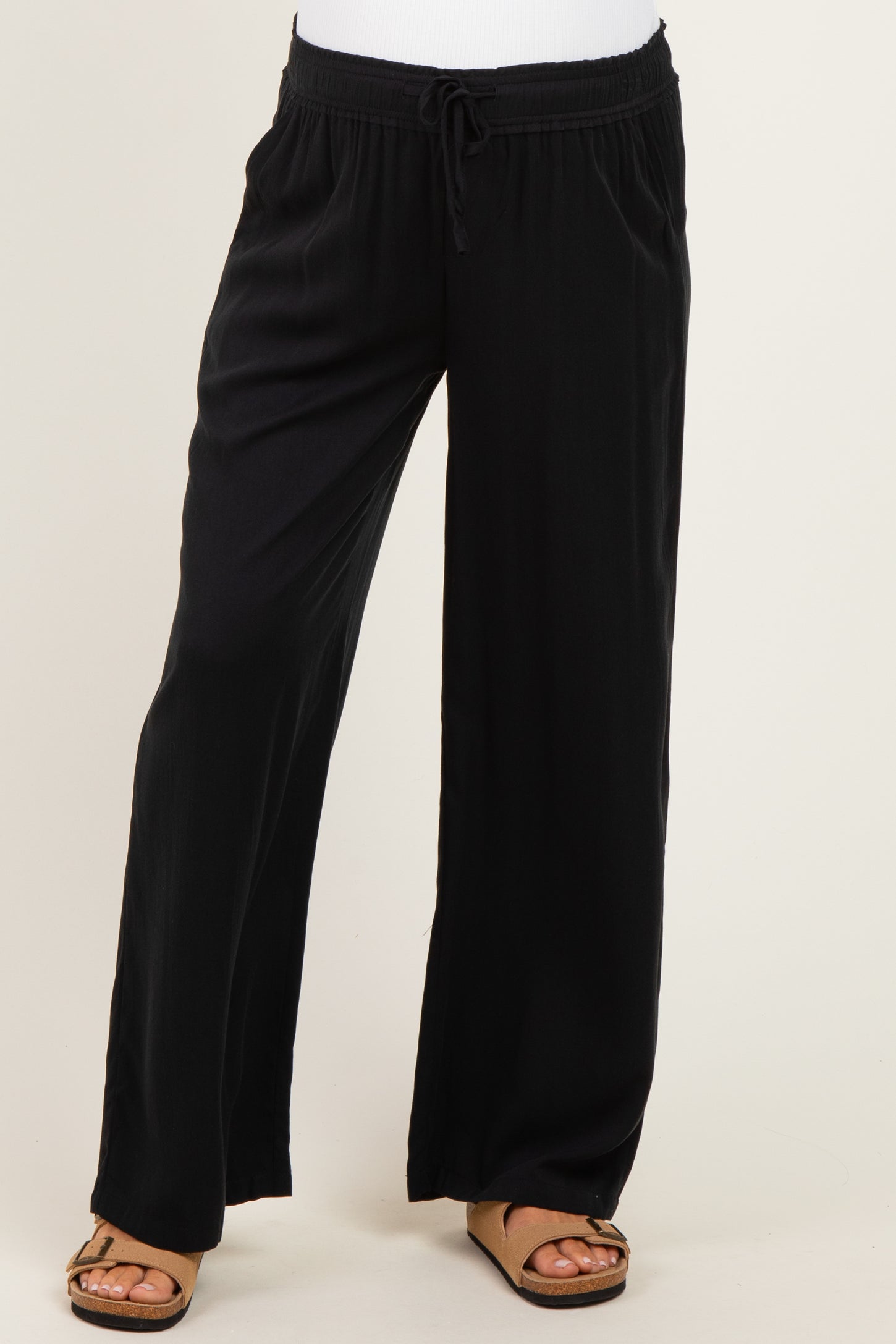 woman wearing black maternity wide-leg pants with a drawstring waistband