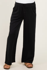 woman wearing black maternity wide-leg pants with a drawstring waistband