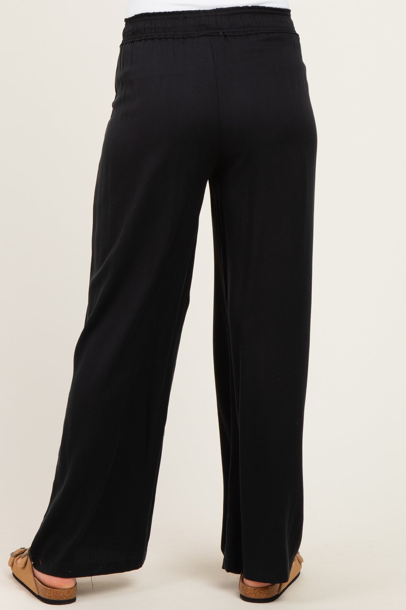 black maternity wide leg pants with an elastic waistband, shown from the back