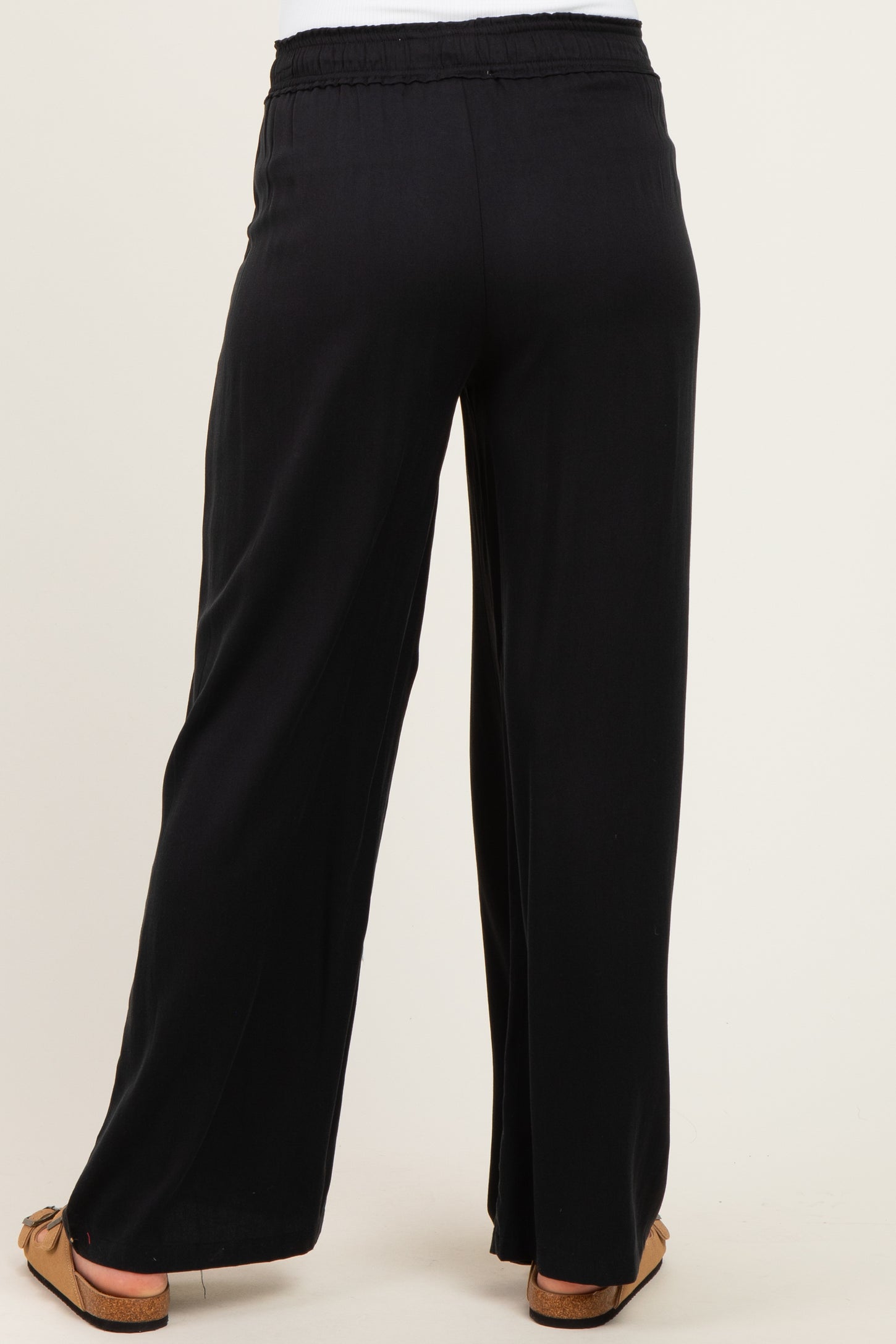 black maternity wide leg pants with an elastic waistband, shown from the back