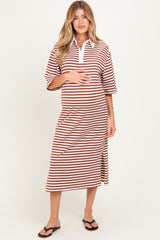 woman wearing a brown and white striped maternity dress with a polo collar and a side slit, holding her baby bump