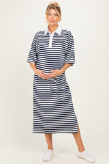 woman wearing a navy and white striped maternity polo dress and holding her baby bump