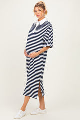 woman wearing a black and white striped maternity polo dress with a side split, gently cradling her baby bump