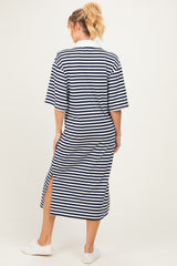 woman wearing a navy and white striped maternity maxi dress with short sleeves and side slits