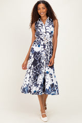 woman wearing a navy blue and white floral midi dress with a fitted bodice and belted waist