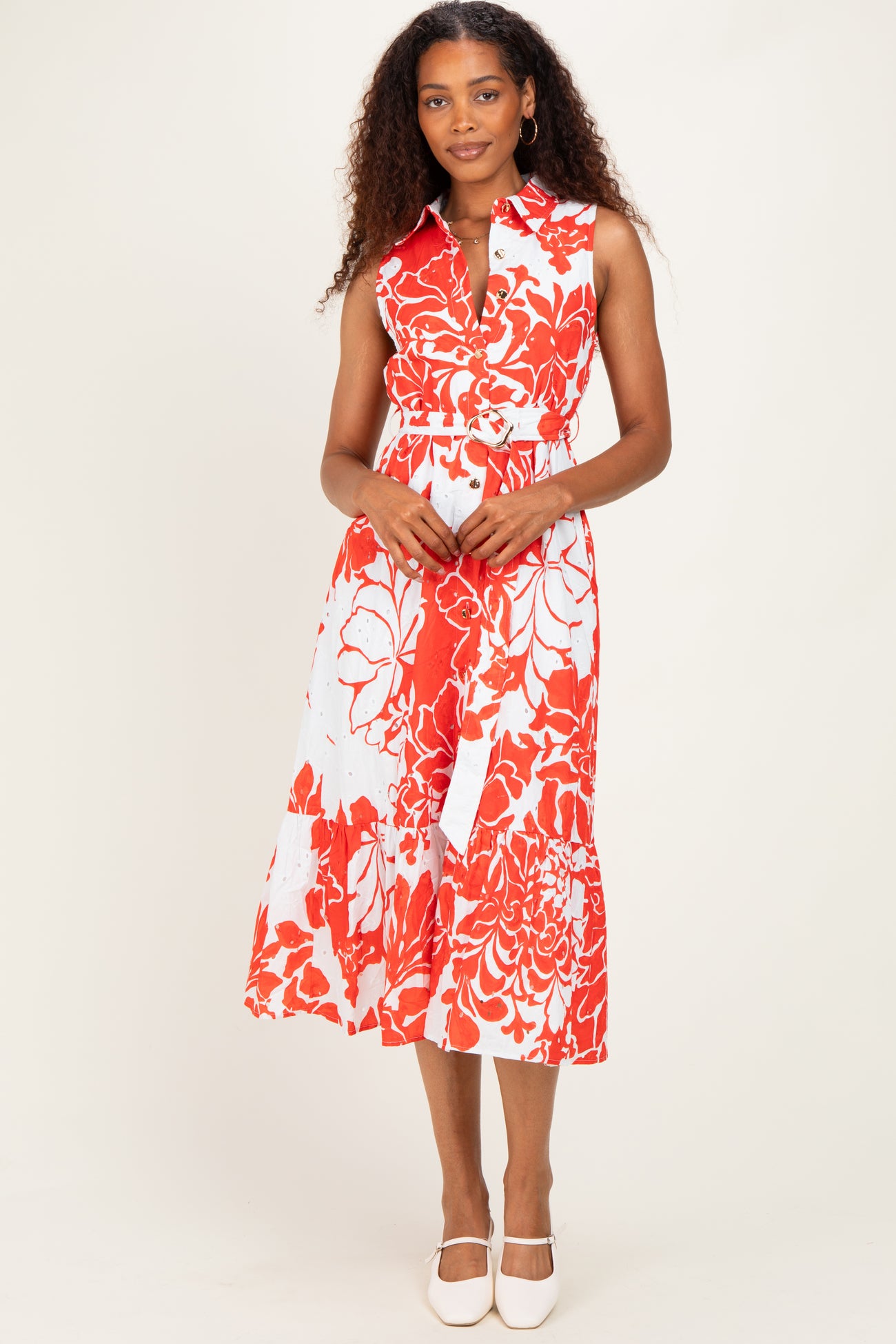 woman wearing a red and white floral midi dress with a collared neckline and a fitted waist