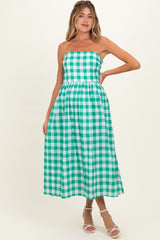 woman wearing a green and white checkered strapless maternity dress with an empire waist