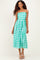 woman wearing a strapless green and white gingham midi dress with a cinched waist and flowy skirt