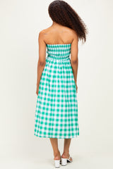 woman wearing a green and white checkered strapless maxi dress with a smocked bodice and a flowing skirt