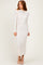 woman wearing a light beige long sleeve midi dress with a fitted silhouette and a slightly frayed hem