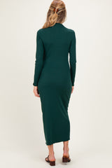 woman wearing a dark green long sleeve maternity dress with a form-fitting silhouette