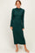 woman wearing a dark green long sleeve ribbed maxi dress and nude heels