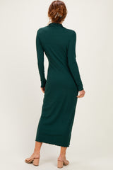 woman wearing a dark green long sleeve ribbed maxi dress with a fitted silhouette and a turtleneck detail