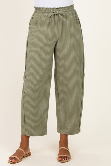 women wearing olive green striped wide-leg pants with an elastic waistband and pockets