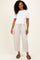 woman wearing a white short sleeve top and light beige wide-leg pants with side pockets and a relaxed fit