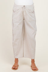 woman wearing light beige breathable maternity pants with a relaxed fit and drawstring waist