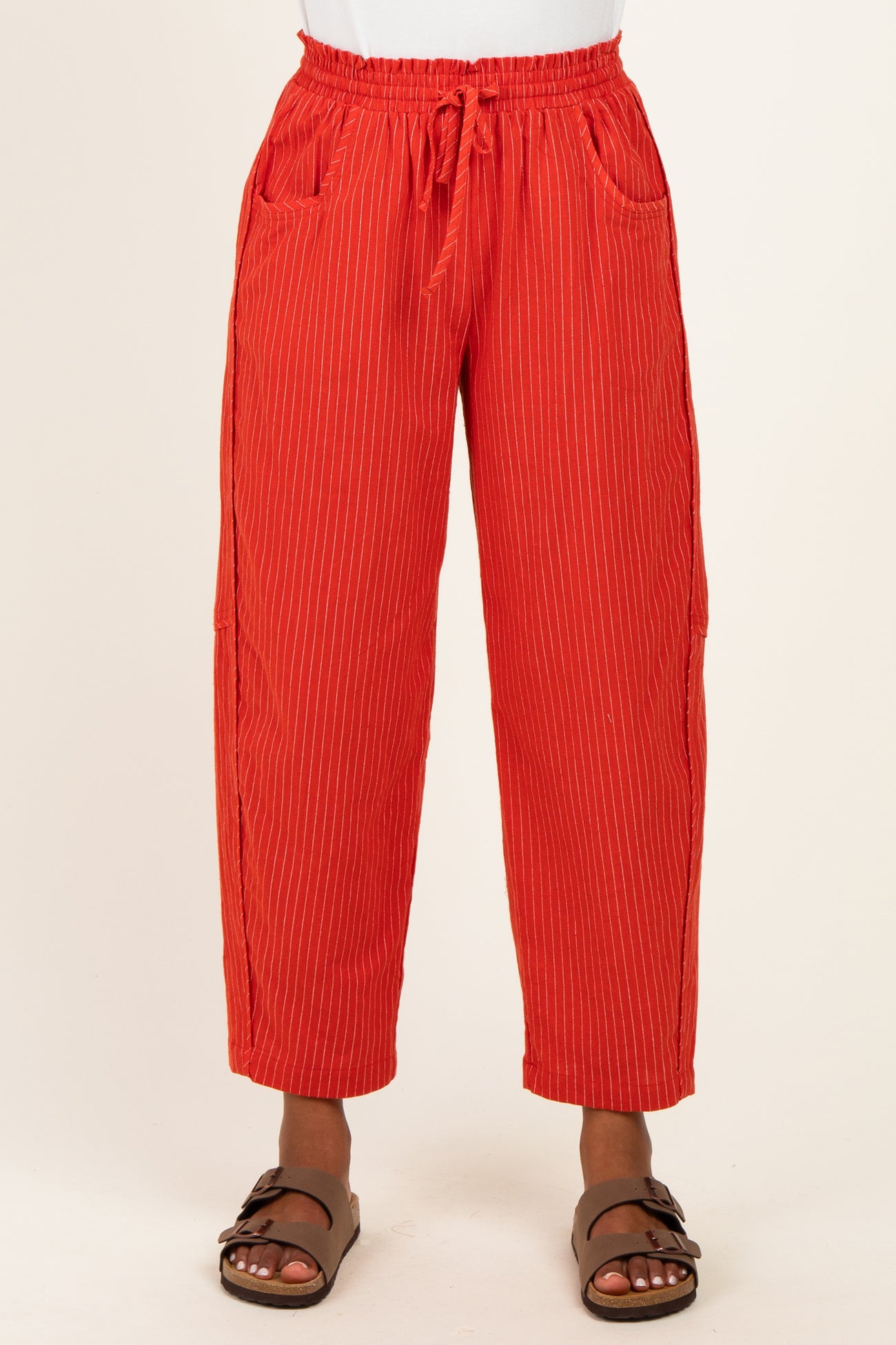 woman wearing red striped casual trousers with an elastic waistband and side pockets