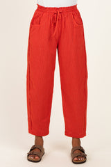 woman wearing red striped casual trousers with an elastic waistband and side pockets