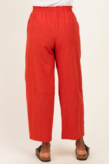 woman wearing red striped wide-leg pants with an elastic waistband, viewed from the back