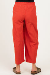 woman wearing red striped maternity culotte pants seen from the back