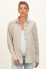 woman wearing a beige and white striped maternity shirt with buttons, showing her baby bump